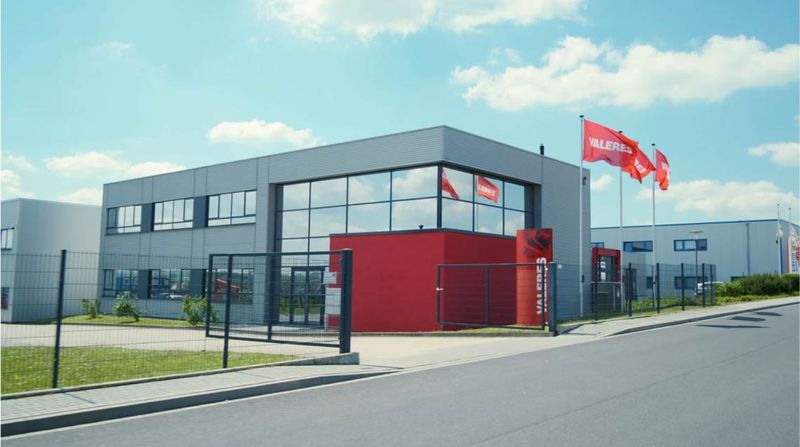 A building flying red flags that say Valeres.